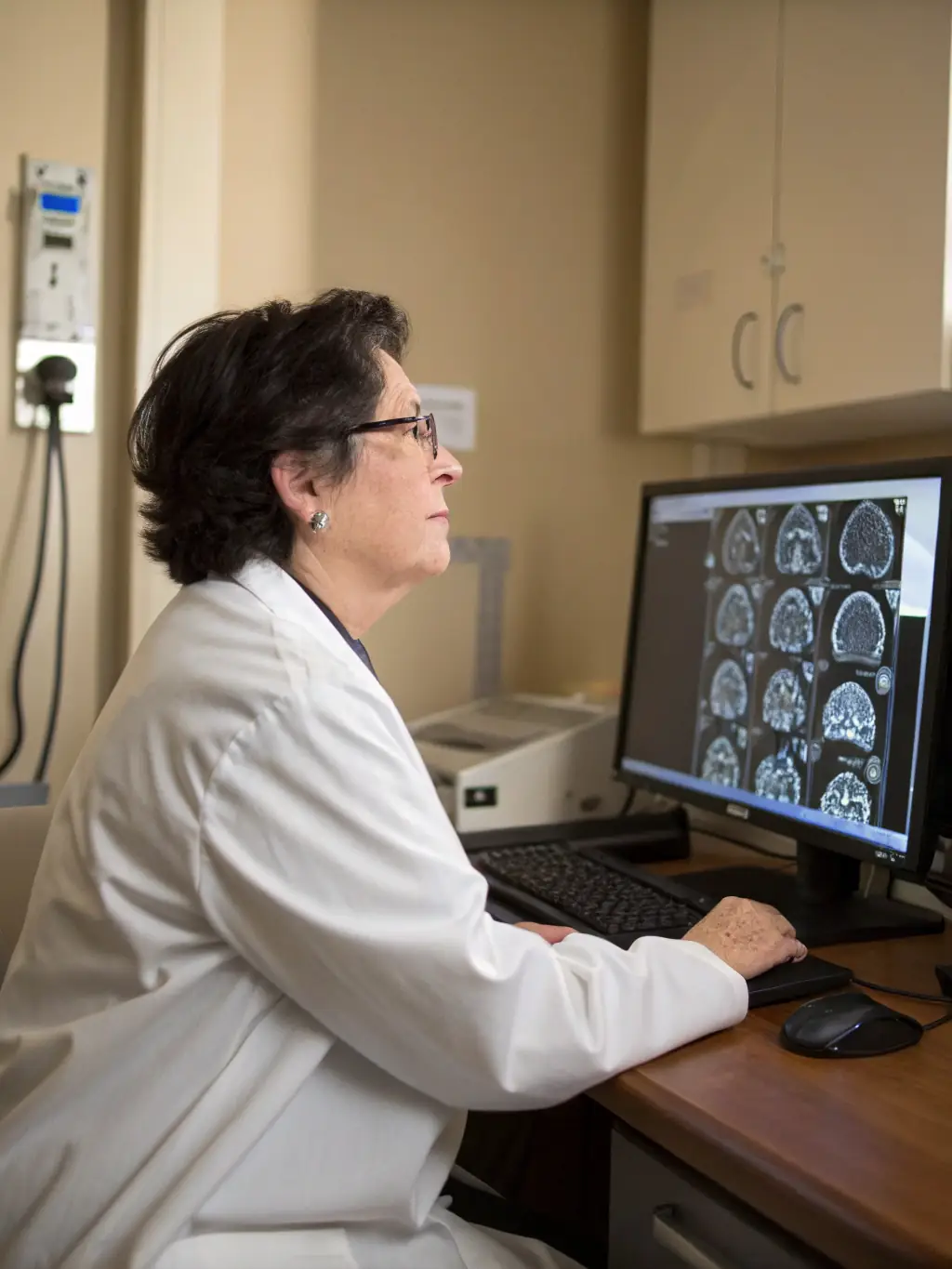 A mental health professional reviewing detailed neuropsychological test results on a tablet, emphasizing comprehensive ADHD evaluation.